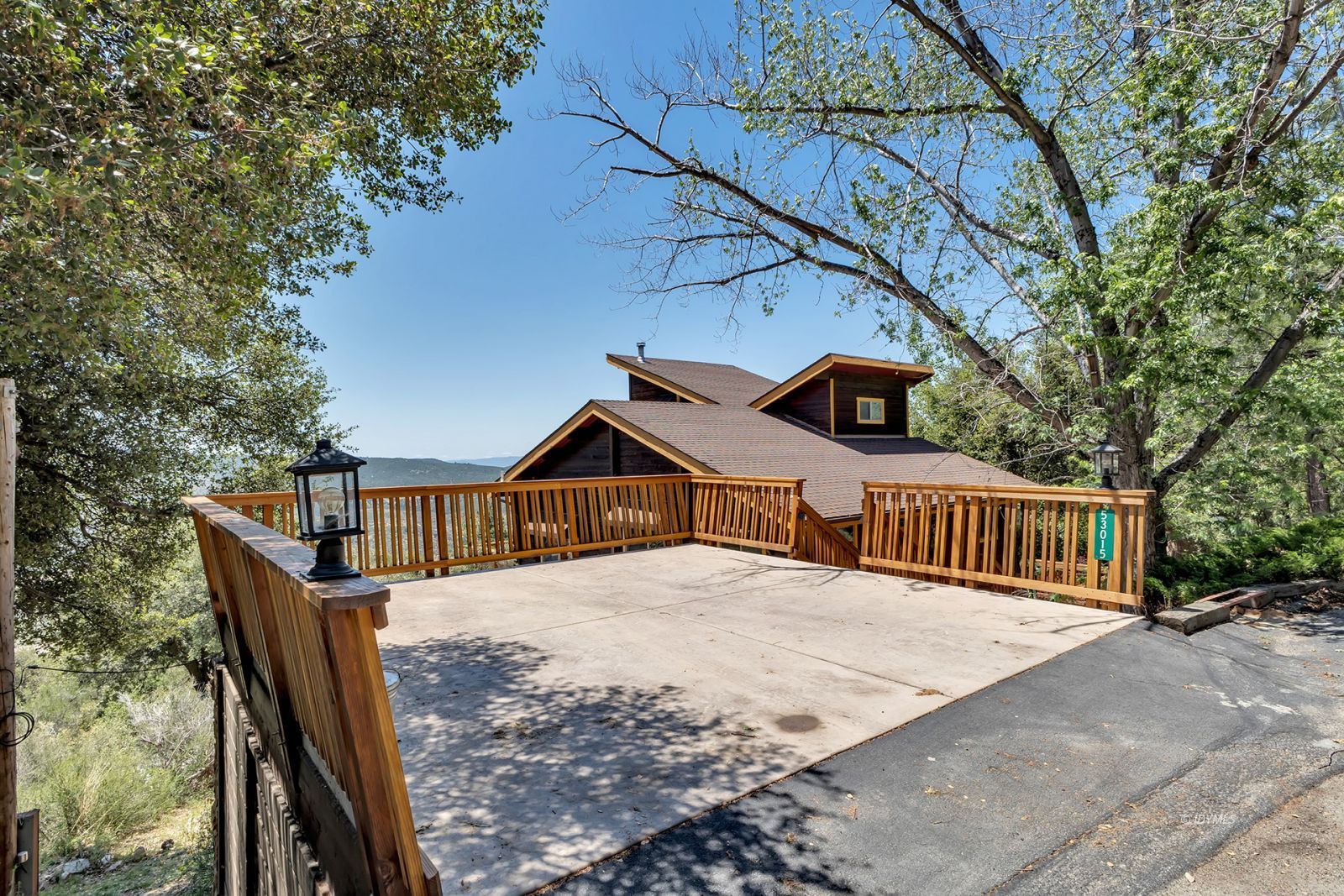 53015 Double View Drive Idyllwild, CA 92549 - Photo 13 of 99 a view of a house with a wooden deck next to a yard