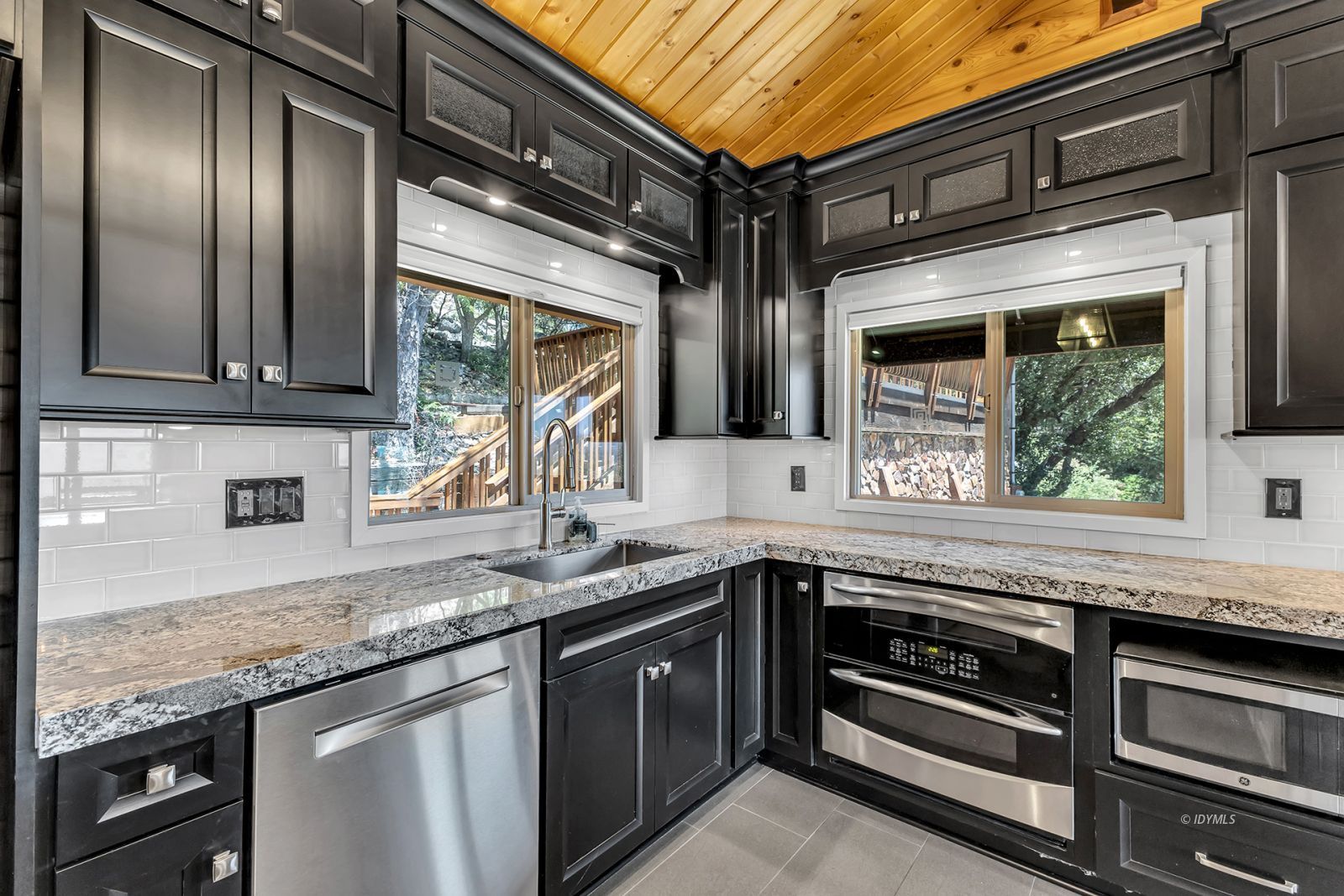 53015 Double View Drive Idyllwild, CA 92549 - Photo 34 of 99 a kitchen with granite countertop stainless steel appliances and wooden cabinets