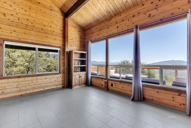 a spacious bedroom with a large bed and dresser