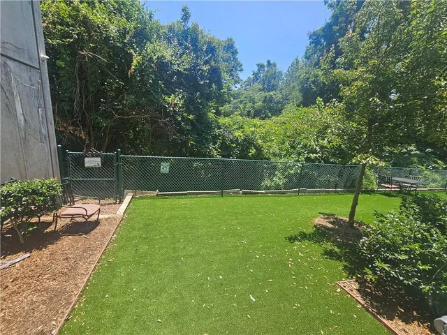 a living room with furniture pool table and a flat screen tv