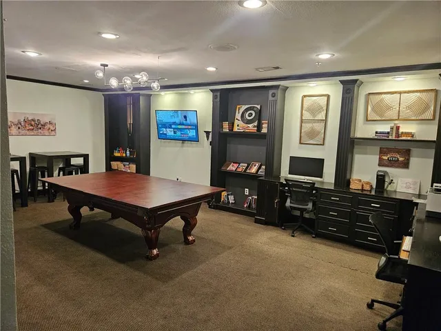 a room with furniture pool table and window