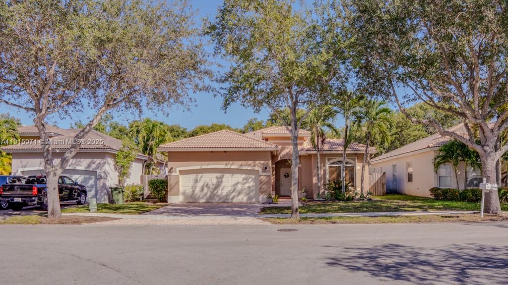a front view of a house with a yard and garage