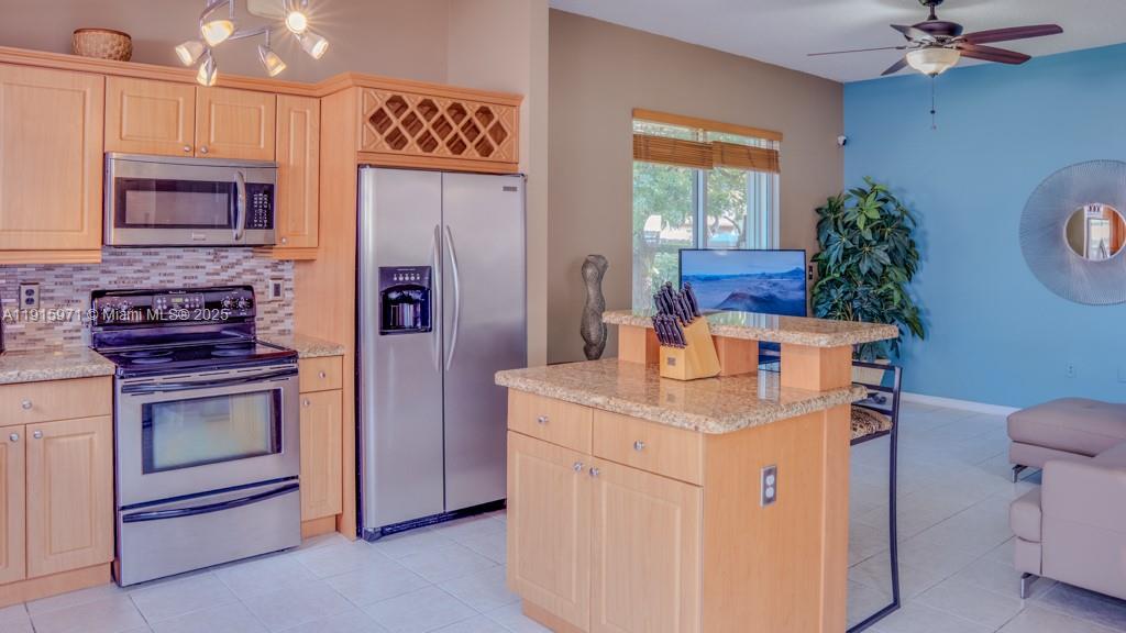 1701 Southeast 17th Avenue Homestead, FL 33035 - Photo 11 of 25 a kitchen that has a stove and a refrigerator