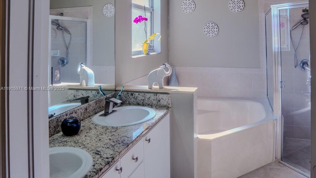 1701 Southeast 17th Avenue Homestead, FL 33035 - Photo 17 of 25 a bathroom with a granite countertop sink and a mirror