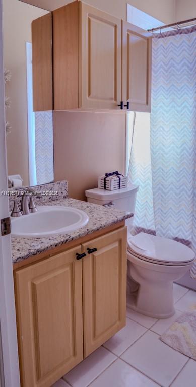 1701 Southeast 17th Avenue Homestead, FL 33035 - Photo 19 of 25 a bathroom with a granite countertop toilet sink and mirror