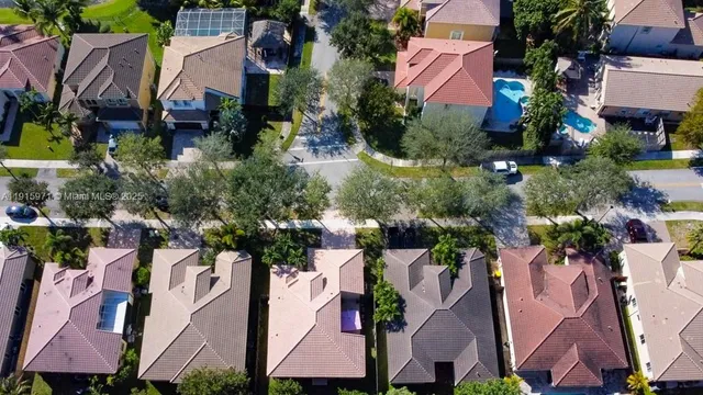an aerial view of a house with a yard and garden