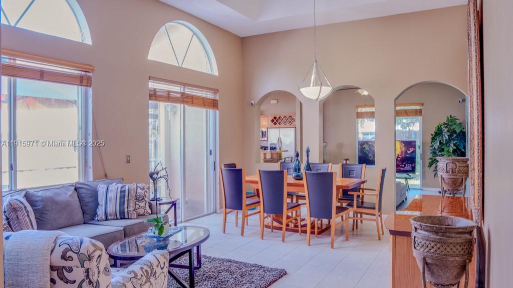 1701 Southeast 17th Avenue Homestead, FL 33035 - Photo 3 of 25 a living room with couches chairs and a large mirror with wooden floor