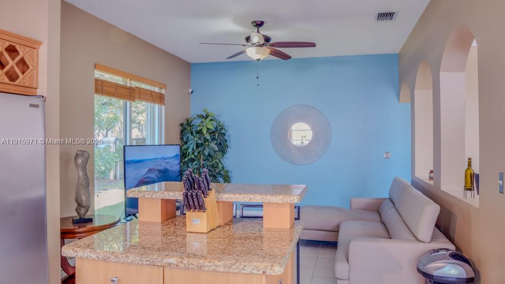 1701 Southeast 17th Avenue Homestead, FL 33035 - Photo 6 of 25 a living room with furniture chandelier and a large window