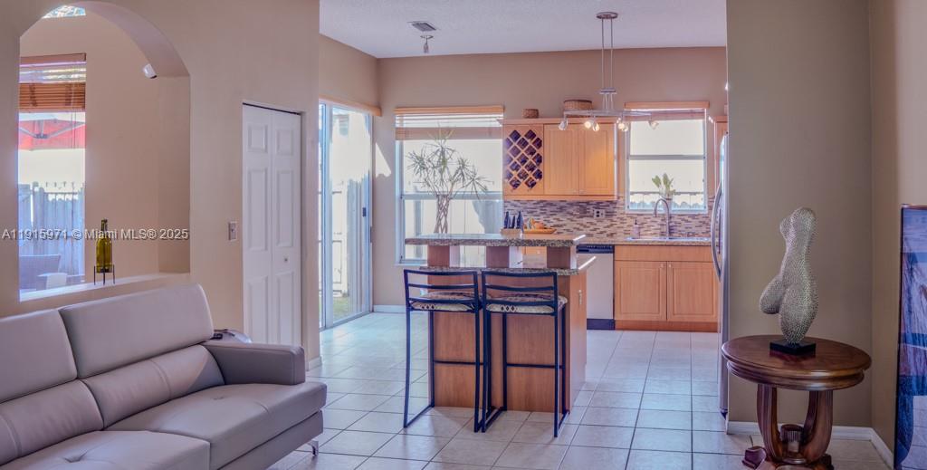1701 Southeast 17th Avenue Homestead, FL 33035 - Photo 8 of 25 a living room with furniture and a chandelier