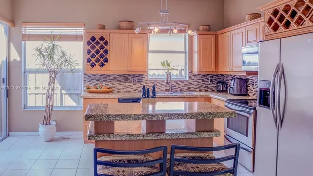 a kitchen with a refrigerator and a stove