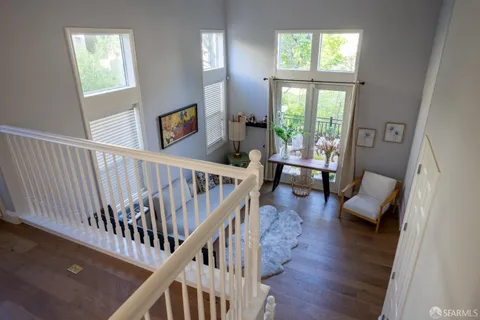 a view of entryway livingroom and hall with wooden floor