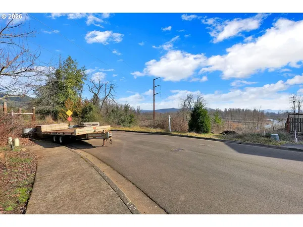 a view of a road with a cars parked on the road