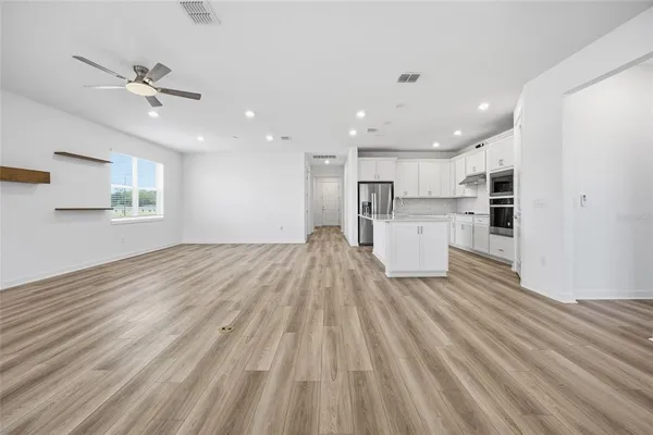 a kitchen with white cabinets and white appliances