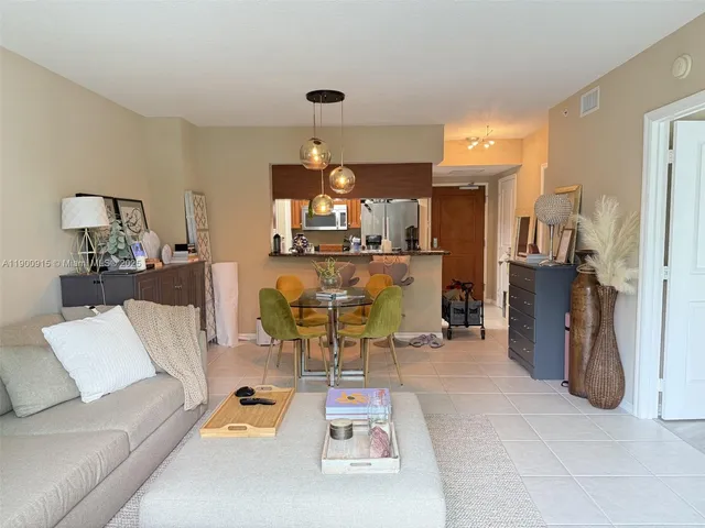 a living room with furniture and a chandelier