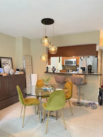 a dining room with furniture and chandelier