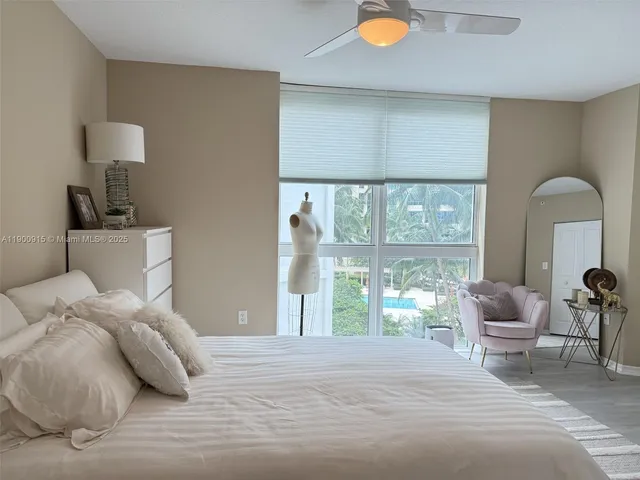 a bedroom with a bed and a large window