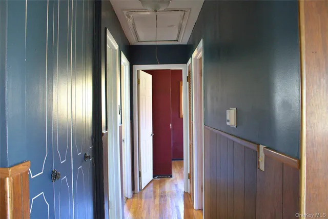 a view of a hallway with wooden floor and entryway