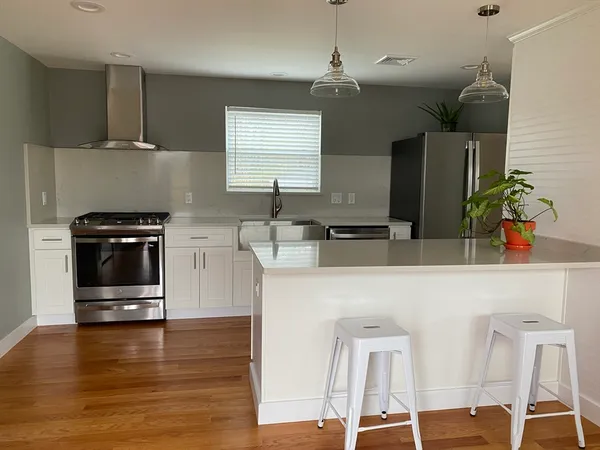 a kitchen with stainless steel appliances a microwave a stove and cabinets
