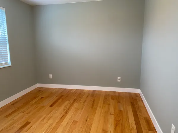 a view of a room with wooden floor and small space