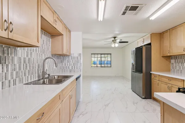 a kitchen with a stove sink and refrigerator
