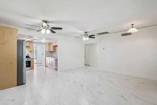 a kitchen with stainless steel appliances granite countertop a sink and a refrigerator