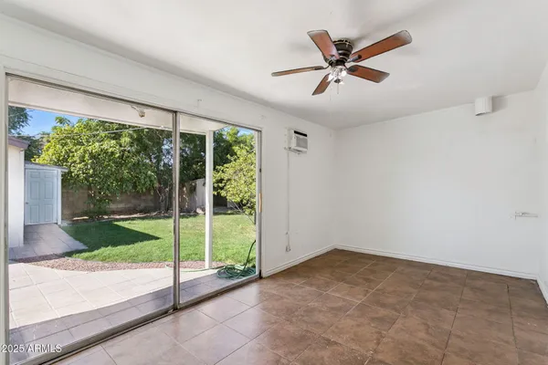 a view of a livingroom with a ceiling fan a ceiling fan and kitchen view