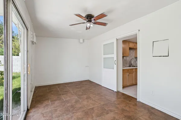 a view of a kitchen with a sink and a ceiling fan