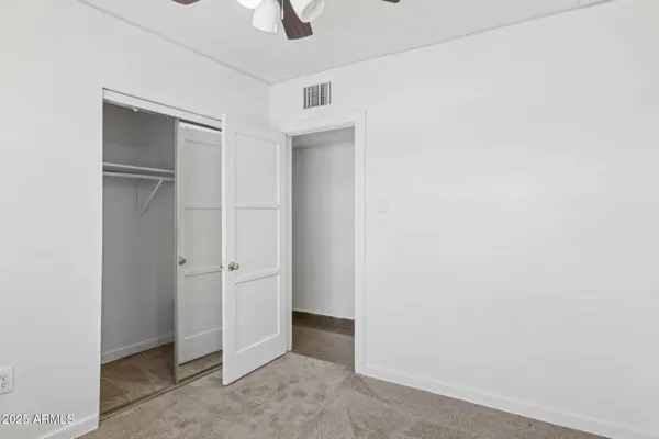 a view of a livingroom with a ceiling fan and a large window