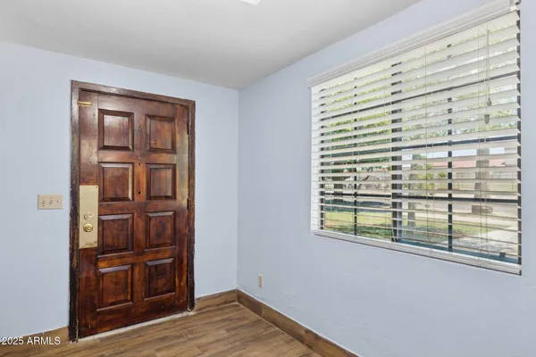 a view of an empty room with closet and a chandelier fan