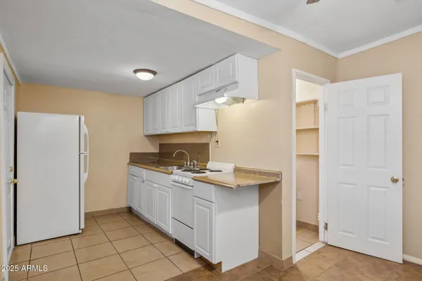 a view of a small space with wooden floor and a window