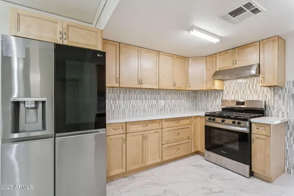 a view of a house with yard and tree s