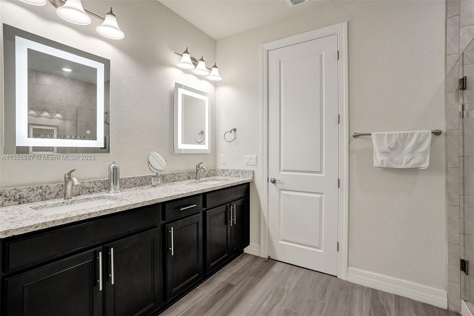 5055 Eucalyptus Drive Hollywood, FL 33021 - Photo 26 of 50 a bathroom with a double vanity sink and mirror