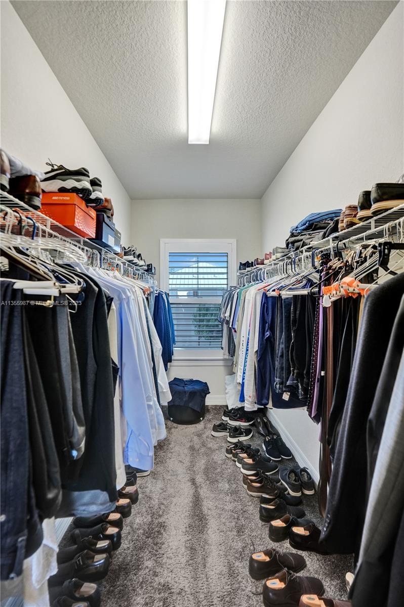 5055 Eucalyptus Drive Hollywood, FL 33021 - Photo 28 of 50 a view of walk in closet with clothes and shoes