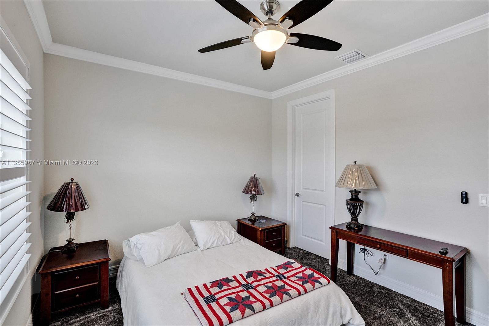 5055 Eucalyptus Drive Hollywood, FL 33021 - Photo 30 of 50 a bedroom with a bed and a chandelier