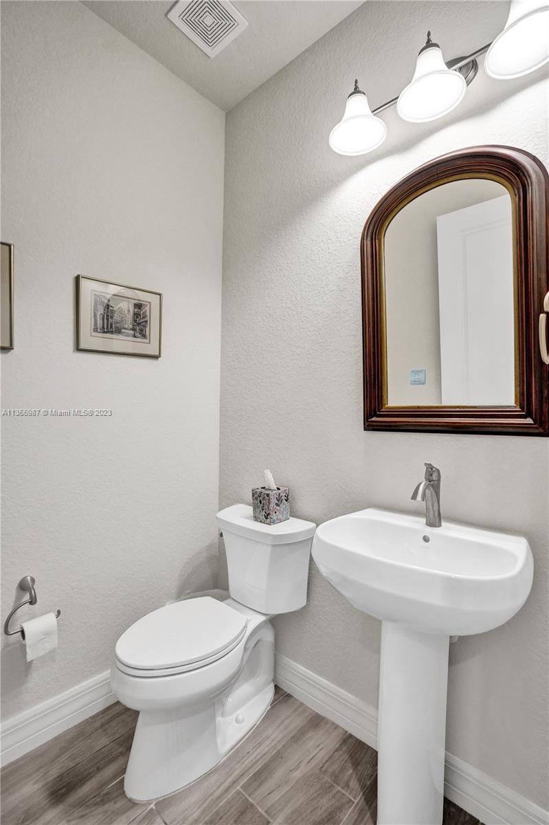 5055 Eucalyptus Drive Hollywood, FL 33021 - Photo 4 of 50 a bathroom with a toilet sink and mirror