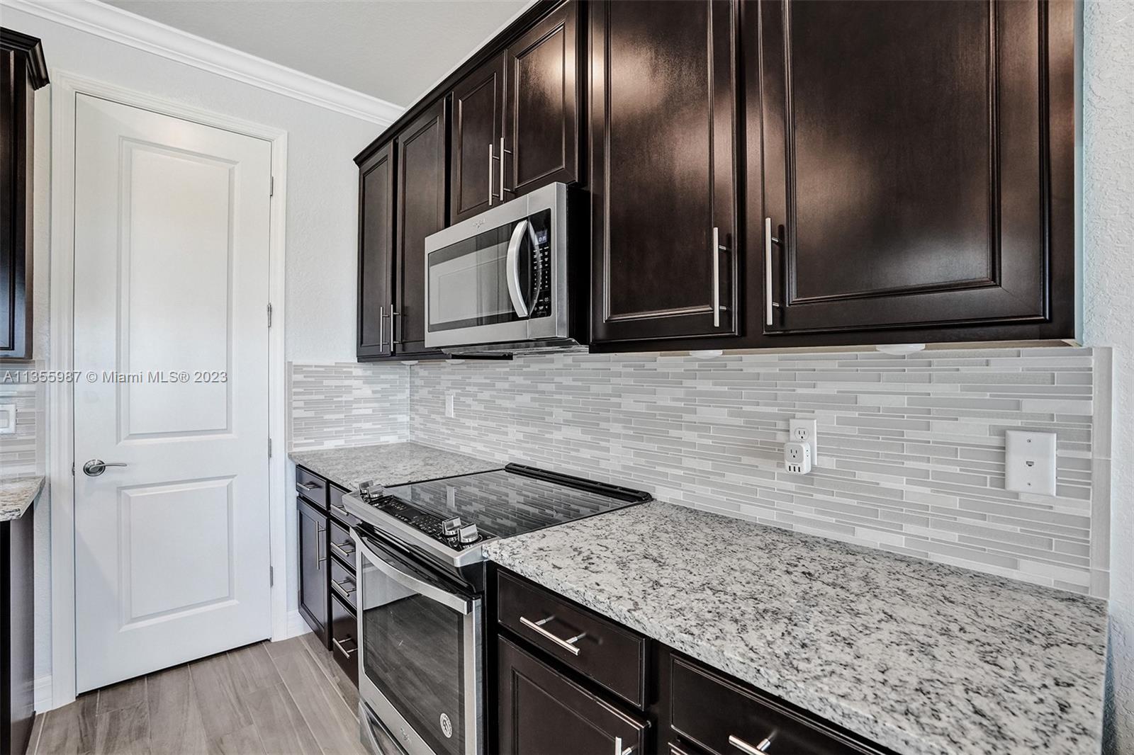 5055 Eucalyptus Drive Hollywood, FL 33021 - Photo 9 of 50 a kitchen with granite countertop stainless steel appliances and cabinets