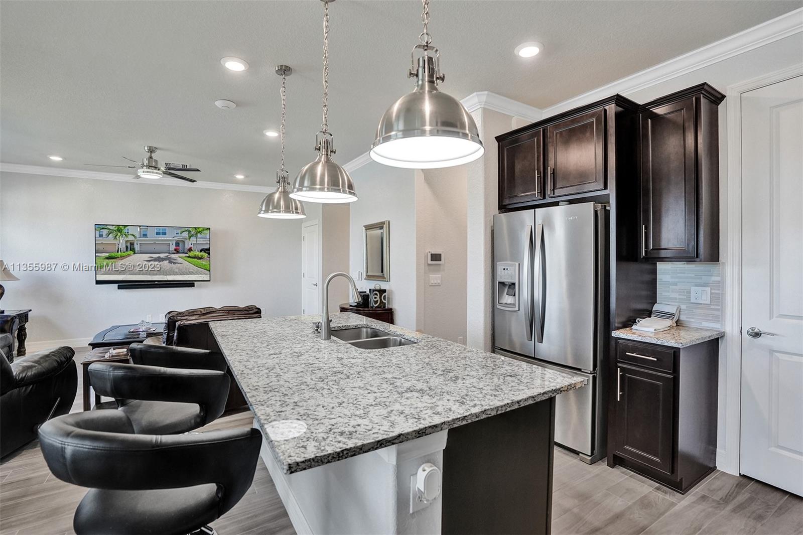 5055 Eucalyptus Drive Hollywood, FL 33021 - Photo 10 of 50 a kitchen with stainless steel appliances granite countertop a sink a refrigerator and a refrigerator