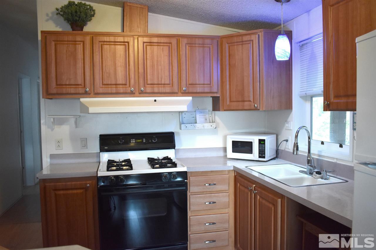 260 Zircon Drive Reno, NV 89521 - Photo 6 of 17 a kitchen with granite countertop a stove sink and cabinets
