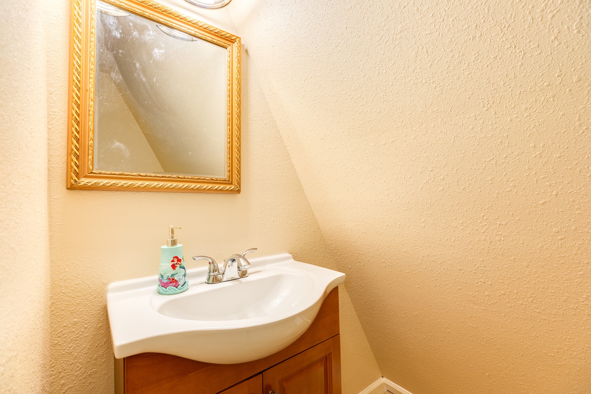131 Point Lafitte Court Surfside Beach, TX 77541 - Photo 22 of 28 a bathroom with a sink a mirror and a vanity