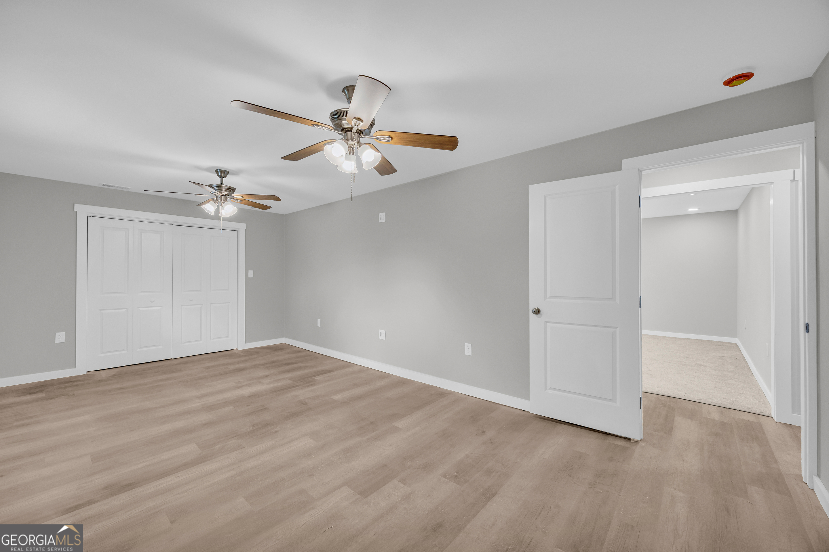 8606 Holly Springs Road Maysville, GA 30558 - Photo 60 of 74 a view of an empty room with a ceiling fan and window