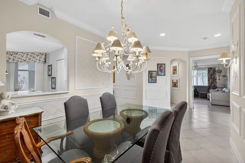 a dining room with furniture and chandelier