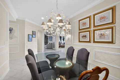 a living room with furniture and large windows