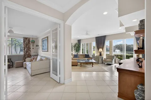 a living room with furniture and large windows