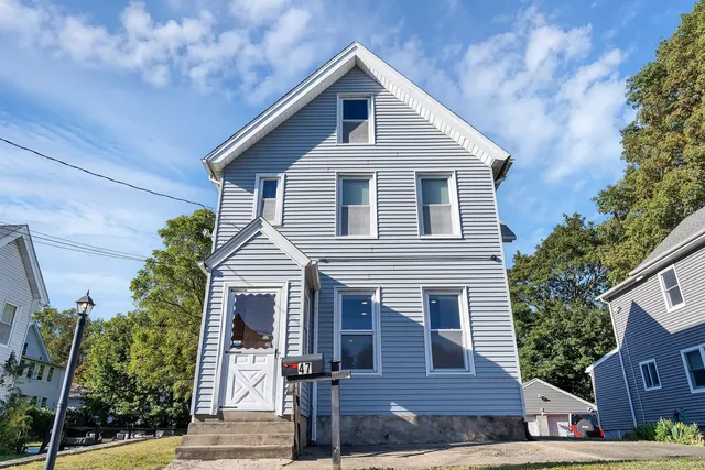 a front view of a house with a yard
