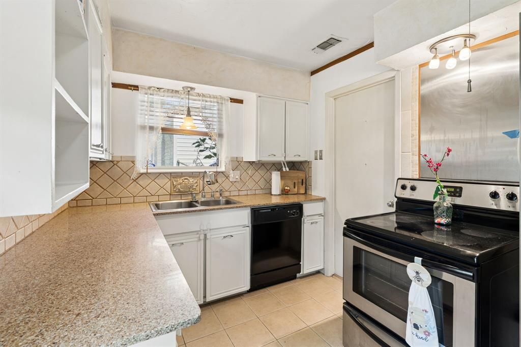 a kitchen with a sink stove and cabinets