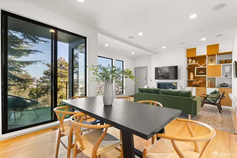 a living room with kitchen island furniture and a potted plant
