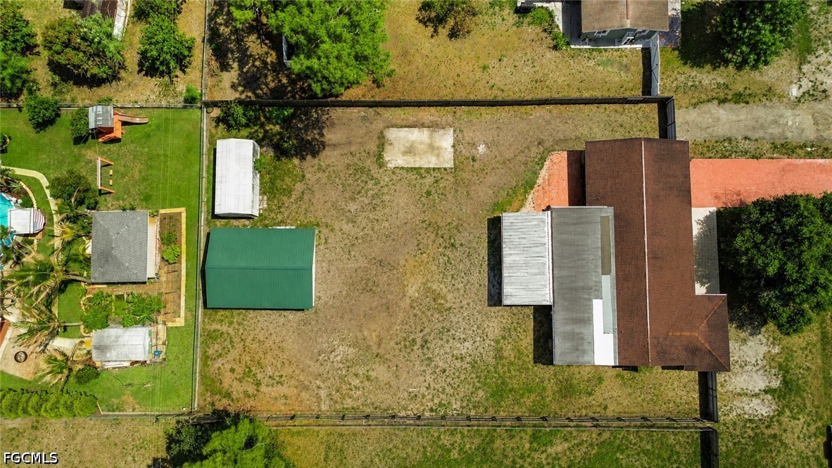 18 Illinois Road Lehigh Acres, FL 33936 - Photo 2 of 45 an aerial view of residential houses with outdoor space