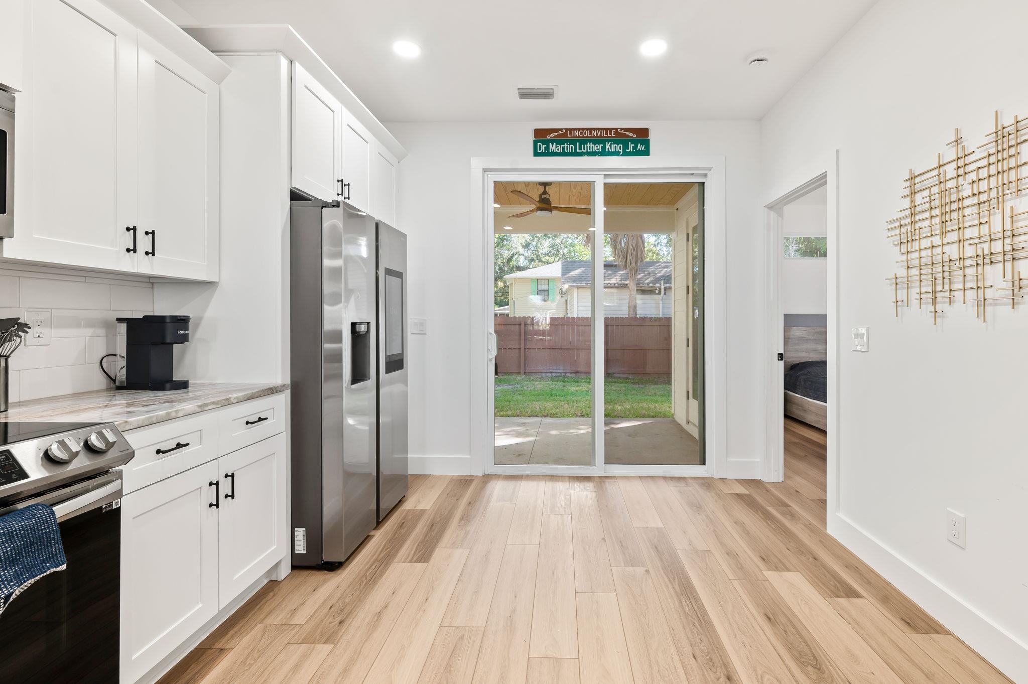 135 Blanco Street St. Augustine, FL 32084 - Photo 11 of 35 a open kitchen with stainless steel appliances a refrigerator and wooden floor