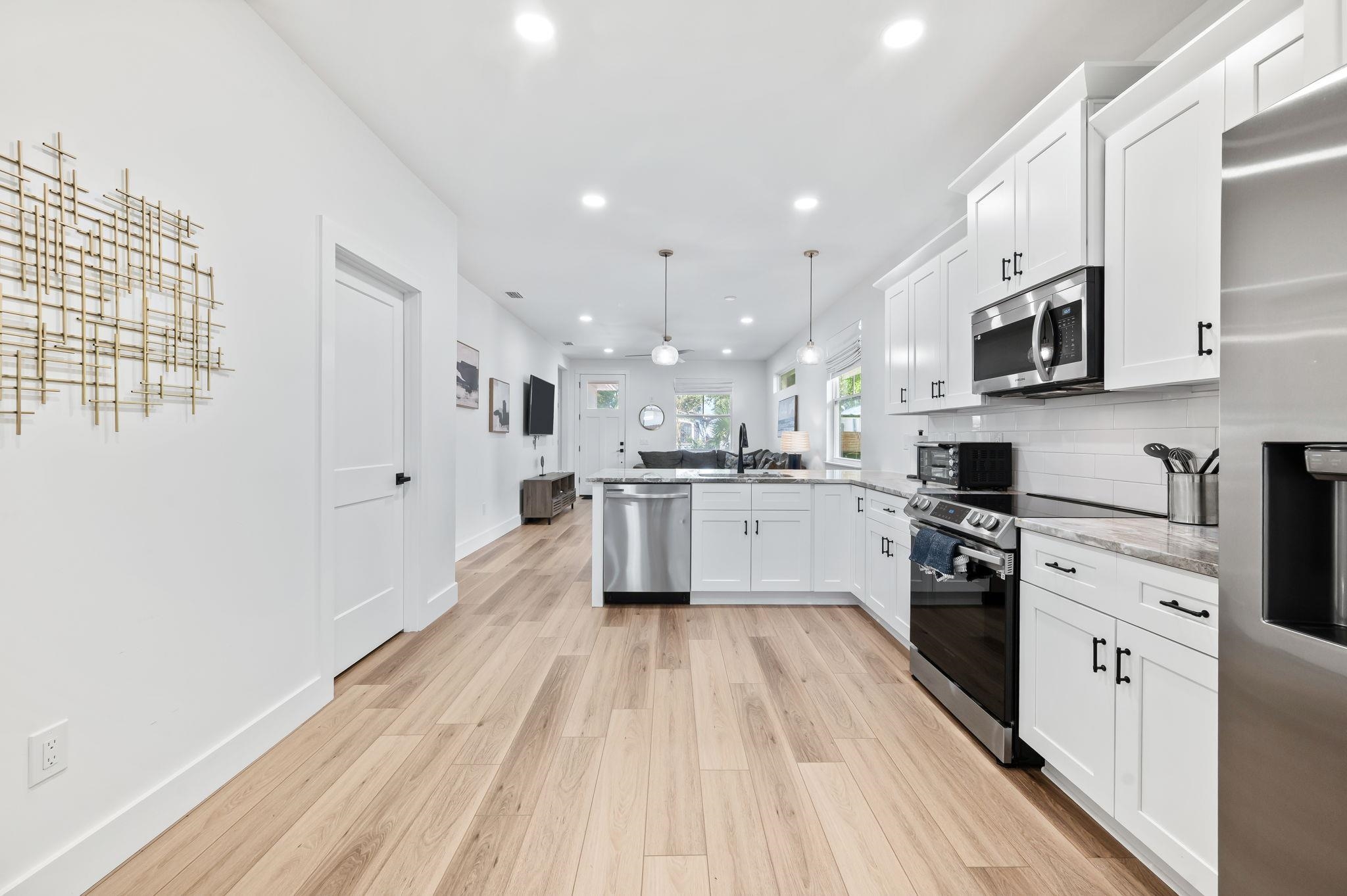 135 Blanco Street St. Augustine, FL 32084 - Photo 12 of 35 a large kitchen with stainless steel appliances granite countertop a lot of counter space and wooden floor