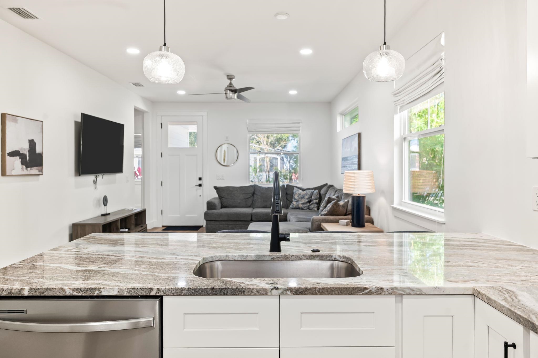 135 Blanco Street St. Augustine, FL 32084 - Photo 13 of 35 a kitchen with kitchen island granite countertop a sink a counter top space appliances and a window